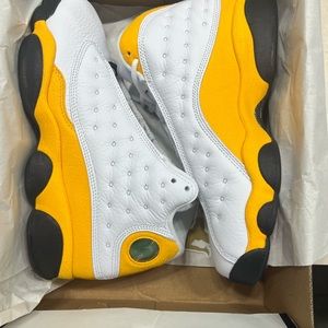 Brand New in the box Jordan Retro 13 Size 6Y Black/Yellow/White.